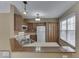 Kitchen with wood cabinets, white appliances, and breakfast bar at 811 Buffalo Run Way, Indianapolis, IN 46227