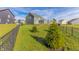 Large backyard with lush green grass, stylish gray siding on the home, and a modern black fence at 8503 Ironhill Ct, Indianapolis, IN 46259