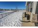 Snowy backyard with a partially visible patio and fence at 8503 Ironhill Ct, Indianapolis, IN 46259