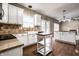 Bright kitchen featuring white cabinetry, stainless appliances, and hardwood floors at 9036 Tilly Mill Rd, Indianapolis, IN 46278