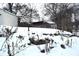 Snowy backyard with retaining wall and landscaping at 906 Raible Ave, Anderson, IN 46011