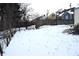 Snowy backyard with wood fence and basketball hoop at 906 Raible Ave, Anderson, IN 46011