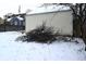 Pile of branches in snowy backyard next to shed at 906 Raible Ave, Anderson, IN 46011