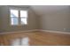 Bright bedroom with hardwood floors and large windows at 906 Raible Ave, Anderson, IN 46011
