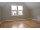 Bright bedroom with hardwood floors and two windows at 906 Raible Ave, Anderson, IN 46011