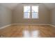 Bright bedroom with hardwood floors and two windows at 906 Raible Ave, Anderson, IN 46011