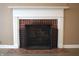 Brick fireplace with white mantel and black metal screen at 906 Raible Ave, Anderson, IN 46011