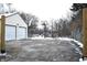 Two-car garage with basketball hoop in snowy driveway at 906 Raible Ave, Anderson, IN 46011