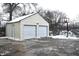 Two-car garage with basketball hoop in snowy yard at 906 Raible Ave, Anderson, IN 46011
