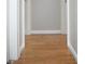 Light hardwood floors and neutral-colored walls in the hallway at 906 Raible Ave, Anderson, IN 46011