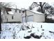 Rear view of house, garage and snowy yard at 906 Raible Ave, Anderson, IN 46011