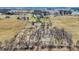 Broad aerial view showing a property's layout including fields, trees, and distant structures at 10194 E 900 N, Markleville, IN 46056