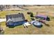 Aerial view of the backyard with a pool, a detached garage, and a well-maintained lawn at 10194 E 900 N, Markleville, IN 46056