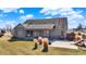 A serene backyard with a covered porch, a patio, and an American flag in the distance at 10194 E 900 N, Markleville, IN 46056