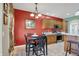 Breakfast nook area with red accent wall and four chairs at 10194 E 900 N, Markleville, IN 46056