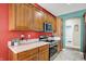 Range, microwave, and wood cabinets in the kitchen at 10194 E 900 N, Markleville, IN 46056