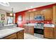 Kitchen with stainless steel appliances and red accent wall at 10194 E 900 N, Markleville, IN 46056