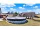 A partially covered above-ground pool surrounded by a deck, creating a private backyard oasis at 10194 E 900 N, Markleville, IN 46056