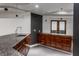 Basement bar with dark wood cabinets and granite countertop at 11091 Crooked Stick Ln, Carmel, IN 46032