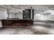 Modern basement bar with granite countertop and wood cabinetry at 11091 Crooked Stick Ln, Carmel, IN 46032