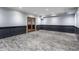 Finished basement office featuring dark gray wainscoting and wood-look floors at 11091 Crooked Stick Ln, Carmel, IN 46032