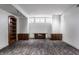 Bright basement room with wood-look floors, built-in shelving, and window at 11091 Crooked Stick Ln, Carmel, IN 46032