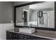 Bathroom with granite countertop, dark vanity, and a large framed mirror at 11091 Crooked Stick Ln, Carmel, IN 46032