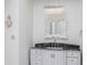 Elegant bathroom with dark vanity, marble countertop, and crystal chandelier at 11091 Crooked Stick Ln, Carmel, IN 46032