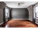Spacious bedroom with hardwood floors and gray accent wall at 11091 Crooked Stick Ln, Carmel, IN 46032