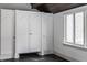 White built-in closet with arched doors and dark stone floor at 11091 Crooked Stick Ln, Carmel, IN 46032
