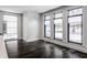 Bright dining room with dark hardwood floors and large windows at 11091 Crooked Stick Ln, Carmel, IN 46032