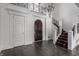 Elegant two-story entryway featuring a dark hardwood floor, a grand staircase, and a crystal chandelier at 11091 Crooked Stick Ln, Carmel, IN 46032