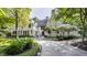 White brick home with a black roof and manicured landscaping at 11091 Crooked Stick Ln, Carmel, IN 46032