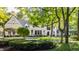Elegant white brick home nestled in a lush green landscape at 11091 Crooked Stick Ln, Carmel, IN 46032