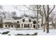 Stunning brick home with a grand facade and charming landscaping, beautifully showcased in a winter setting at 11091 Crooked Stick Ln, Carmel, IN 46032