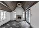 Gathering room features a fireplace, vaulted ceiling, and dark hardwood floors at 11091 Crooked Stick Ln, Carmel, IN 46032