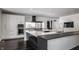 Modern kitchen with large island, stainless steel appliances, and dark countertops at 11091 Crooked Stick Ln, Carmel, IN 46032