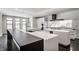 Modern kitchen with large island, stainless steel appliances, and dark countertops at 11091 Crooked Stick Ln, Carmel, IN 46032