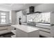 Modern kitchen with expansive island, high-end appliances, and large window at 11091 Crooked Stick Ln, Carmel, IN 46032