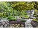 Landscaped backyard with stone pathways and lush greenery at 11091 Crooked Stick Ln, Carmel, IN 46032