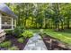 Stone pathway meanders through a beautifully landscaped yard at 11091 Crooked Stick Ln, Carmel, IN 46032