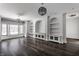 Spacious living room with built-in shelving and hardwood floors at 11091 Crooked Stick Ln, Carmel, IN 46032