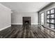 Spacious living room with dark hardwood floors, a modern fireplace, and large windows at 11091 Crooked Stick Ln, Carmel, IN 46032