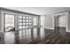 Spacious living room with dark hardwood floors, large windows, and views of the backyard at 11091 Crooked Stick Ln, Carmel, IN 46032