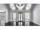 Bright sunroom with vaulted ceilings, dark hardwood floors, and multiple windows offering backyard views at 11091 Crooked Stick Ln, Carmel, IN 46032