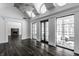 Bright sunroom with vaulted ceilings, dark hardwood floors, and multiple windows offering backyard views at 11091 Crooked Stick Ln, Carmel, IN 46032