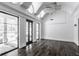 Bright sunroom with vaulted ceilings, dark hardwood floors, and multiple windows offering backyard views at 11091 Crooked Stick Ln, Carmel, IN 46032
