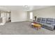 Spacious loft area with gray carpet and a leather couch at 12346 Croquet Way, Indianapolis, IN 46235