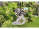 Breathtaking aerial view of sprawling estate with lush landscaping, pool, and circular driveway at 14990 E 104Th St, Fishers, IN 46040