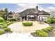 Stone patio with outdoor seating area surrounded by an ornamental bush and trimmed landscaping at 14990 E 104Th St, Fishers, IN 46040